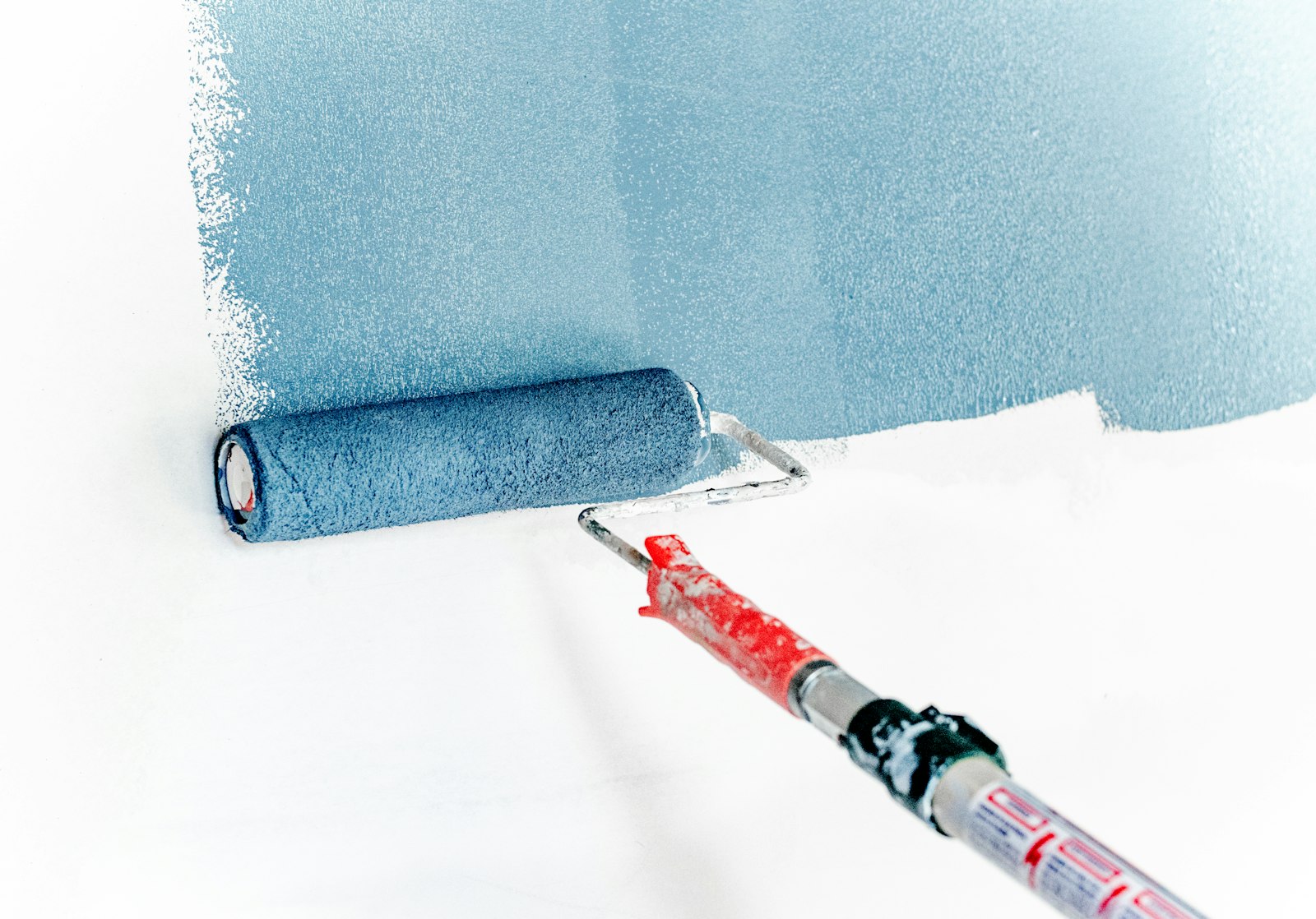 Paint roller applying a clean, even coat to a wall